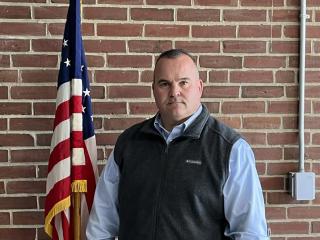 Man Standing in Front of American Flag