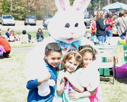 Easter Bunny Hugging Three Children